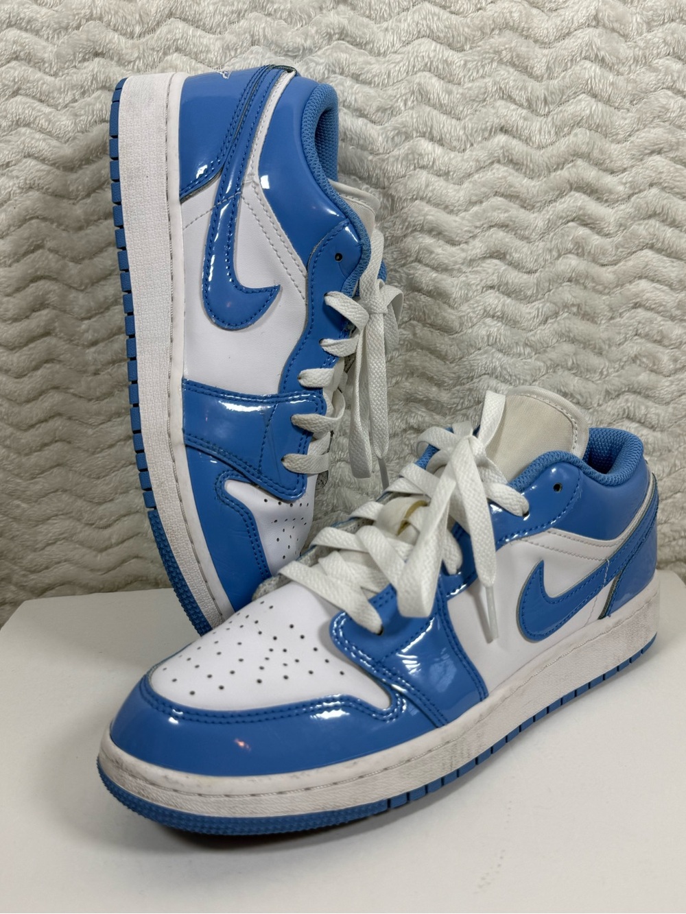 Nike Air Jordan 1 Low SE sneakers in the "Legend Blue" or "UNC Patent" colorway